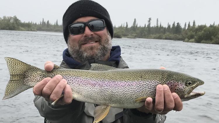 Pete Giacalone, of San Diego, displays one of the rainbow trout caught out of Alaska's Katmai Lodge.