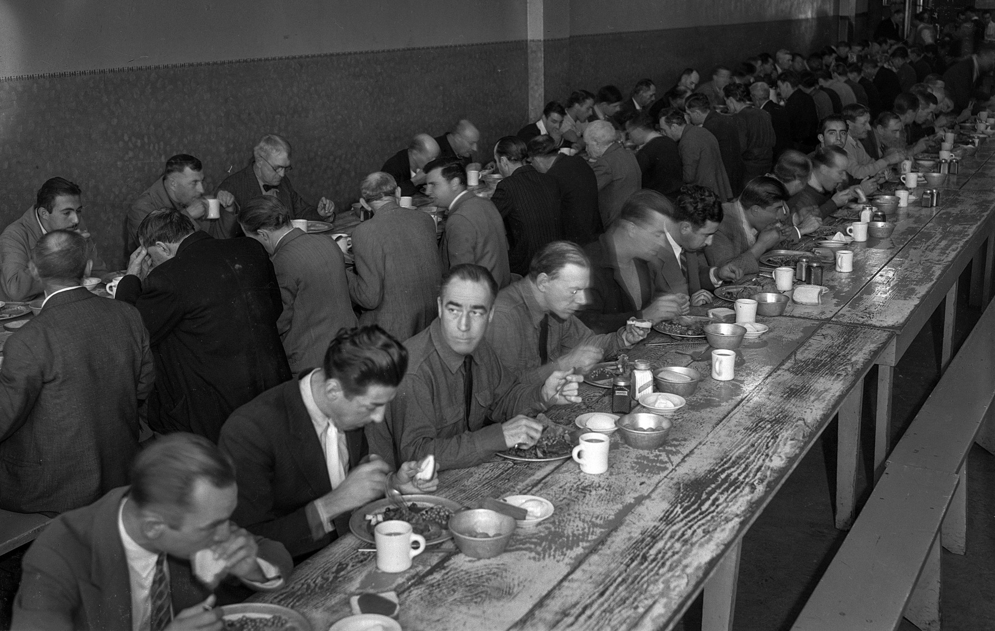 Nov. 28, 1935: Men enjoy Thanksgiving dinner at the Midnight Mission, Los Angeles. Long lines of nee