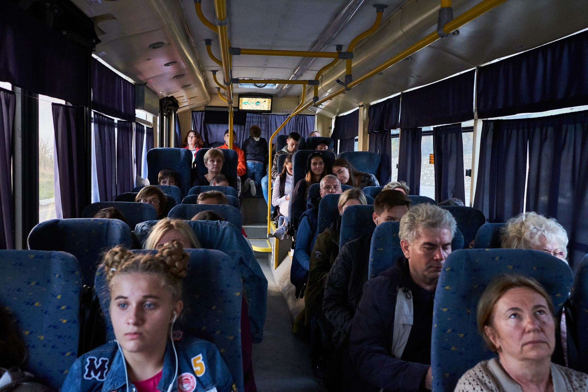 The passengers are sitting inside the trolleybus that goes from Yalta to Simferopol, the Crieman cap