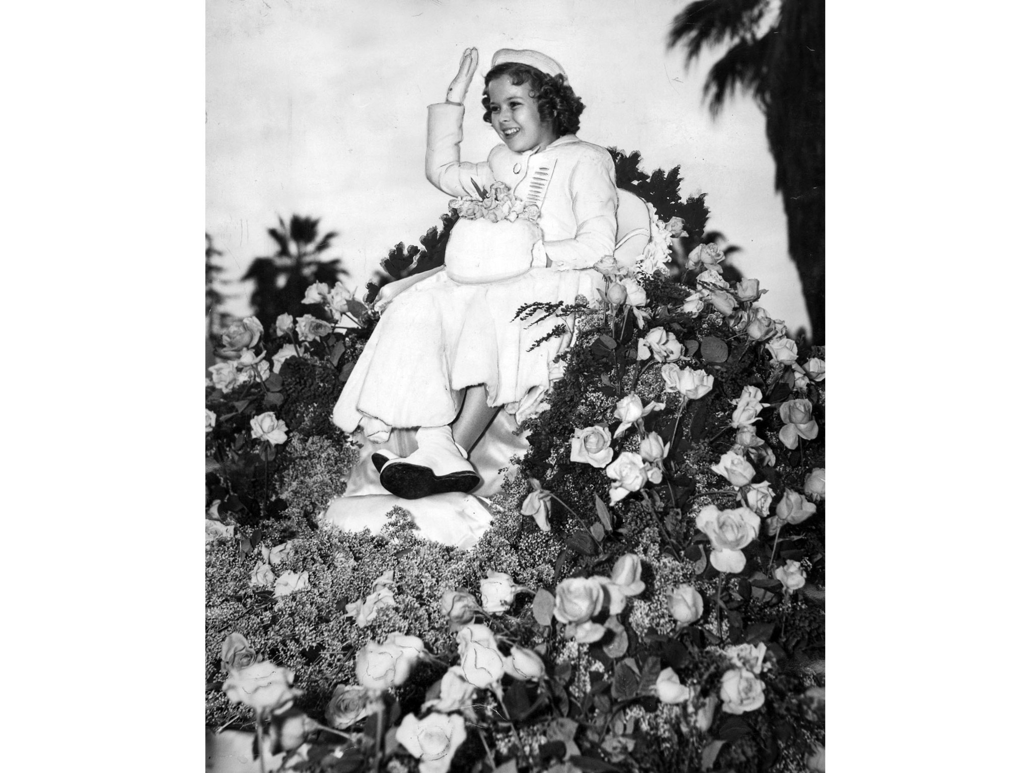 Jan. 2, 1939: Tournament of Roses parade grand marshal Shirley Temple rides on a float covered with