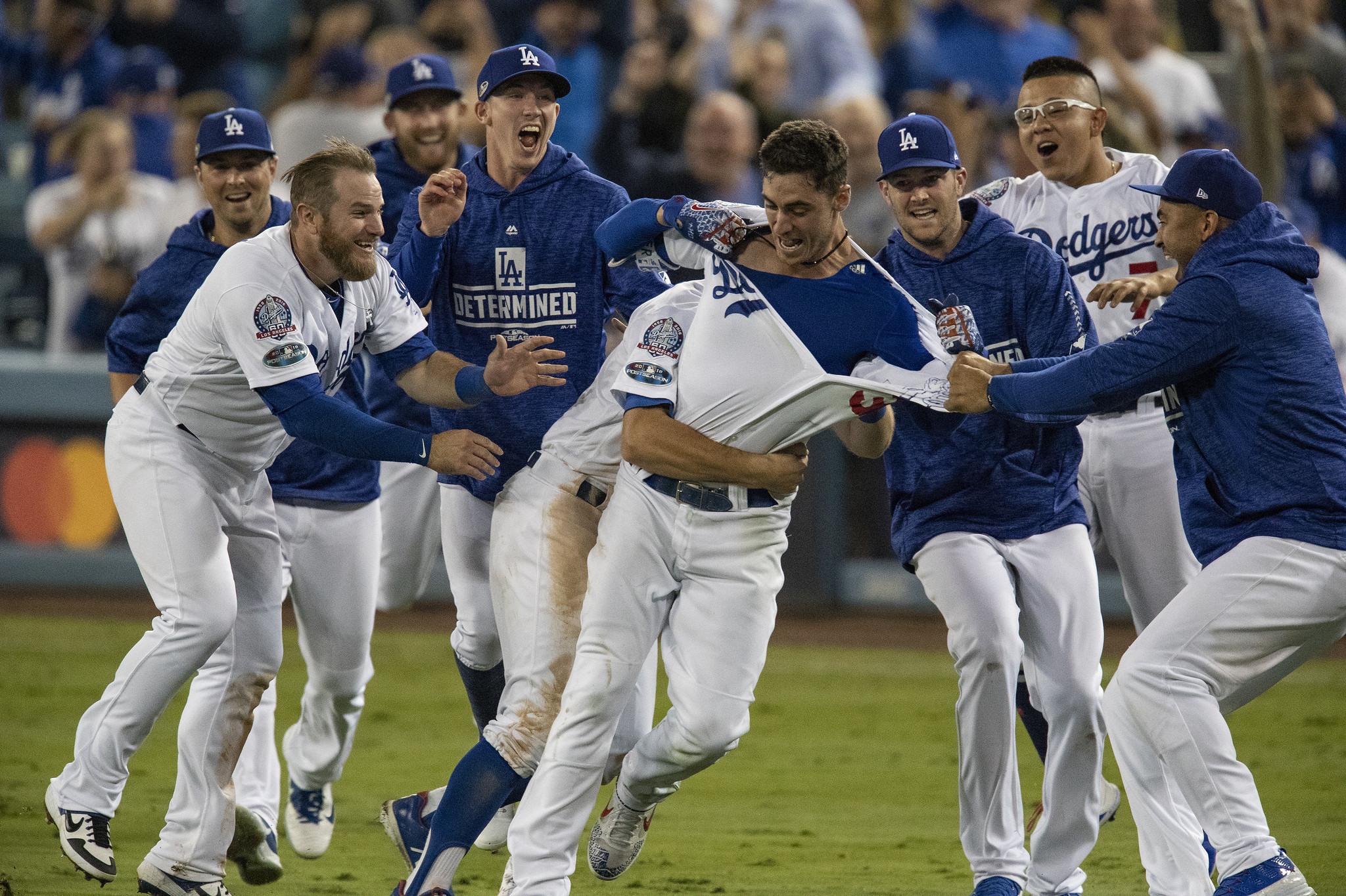 LOS ANGELES, CA - OCTOBER 16, 2018: Teammates mob Los Angeles Dodgers center fielder Cody Bellinger
