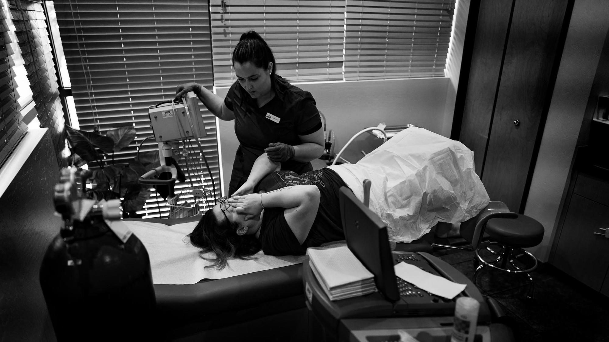 Nurse comforts patient after abortion procedure