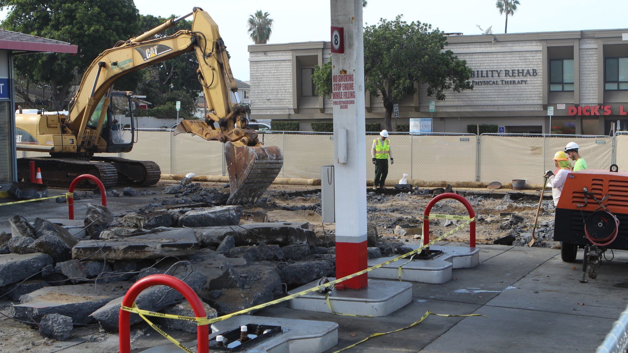 Workers break up the pavement at La Jolla's former Unocal gas station at 801 Pearl St.